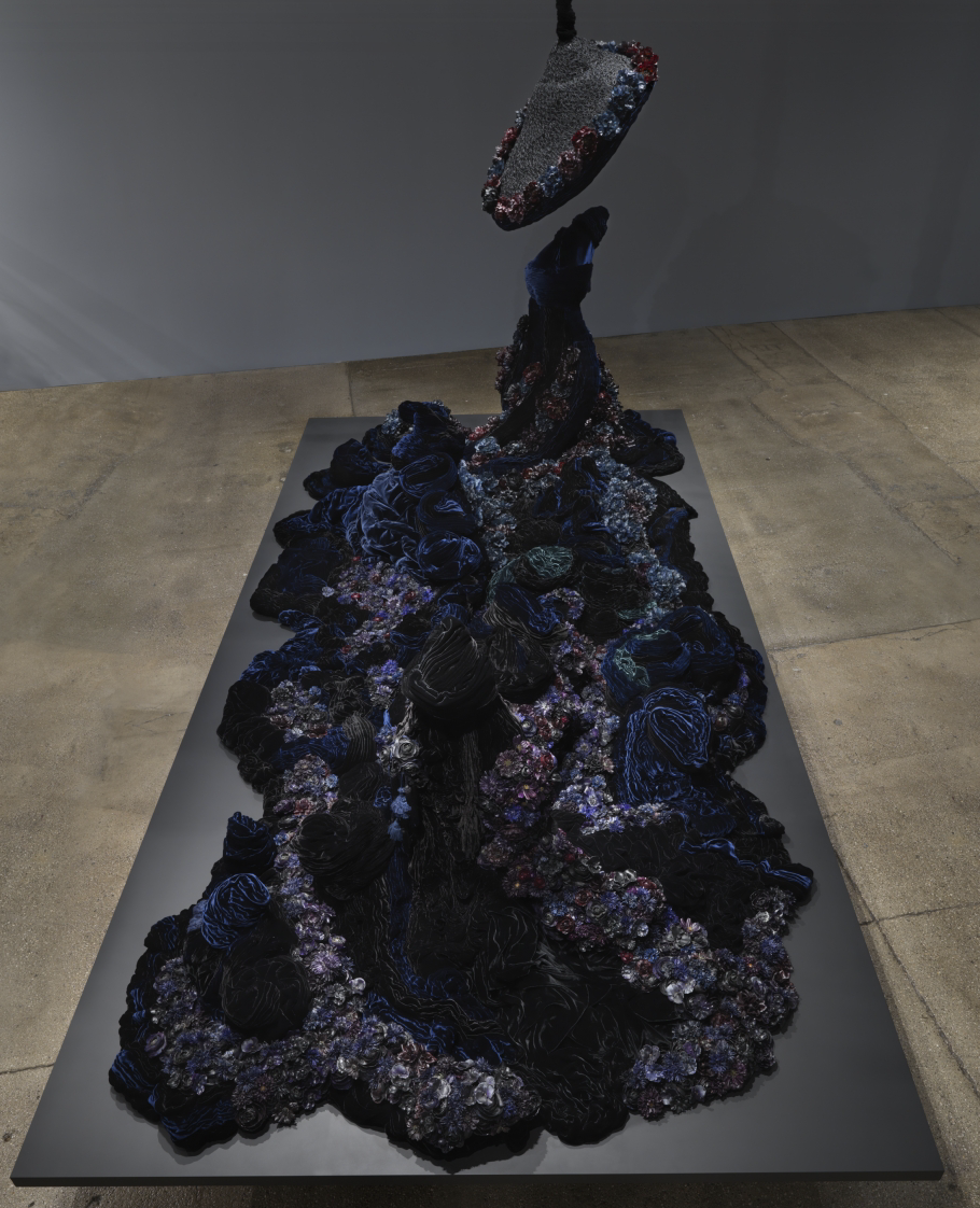 Petah Coyne Untitled #1379 (The Doctor’s Wife), 1997-2018 Specially-formulated wax, pigment, silk flowers, silk/rayon velvet, tassels, Cast-wax statuary figures, human hair, black pearl-headed hat pins, wire, thread, felt, cotton batting, chicken-wire fencing, wood, masonite, steel, acrylic paint, nails, bolts, screws, washers, wing nuts, latches, 3/8″ Grade 30 proof coil chain, cable, cable nuts, shackles, Velcro, plastic 96 x 193.5 x 97.5 inches (243.8 x 491.5 x 247.7 cm)